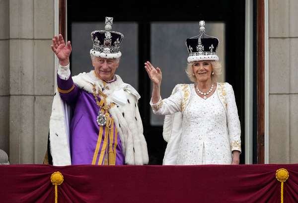 King Charles III and Queen Camilla (Camilla, Queen Consort) wave from the balcony of Buckingham Palace during the Coronation of King Charles in London, England on May 6, 2023